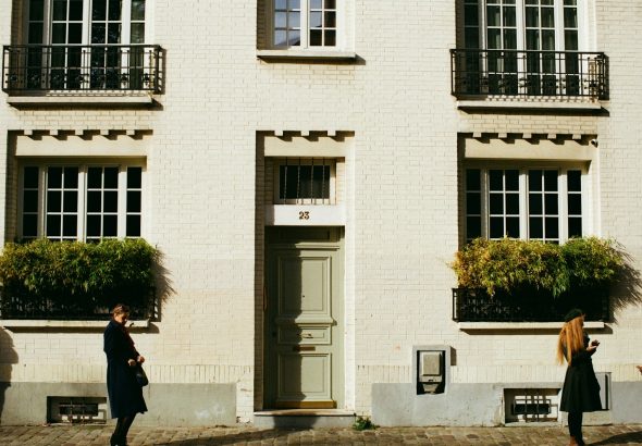 people standing in front of white concrete building during daytime